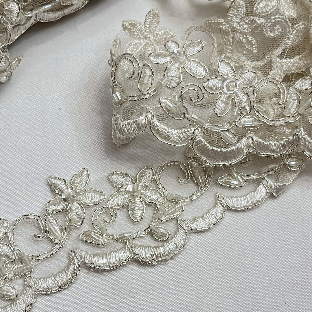 Closeup view of Beaded Ivory with Silver  Cording Lace Trimming Embroidered on 100% Polyester Net Mesh | Lace USA - 97012W-BP
