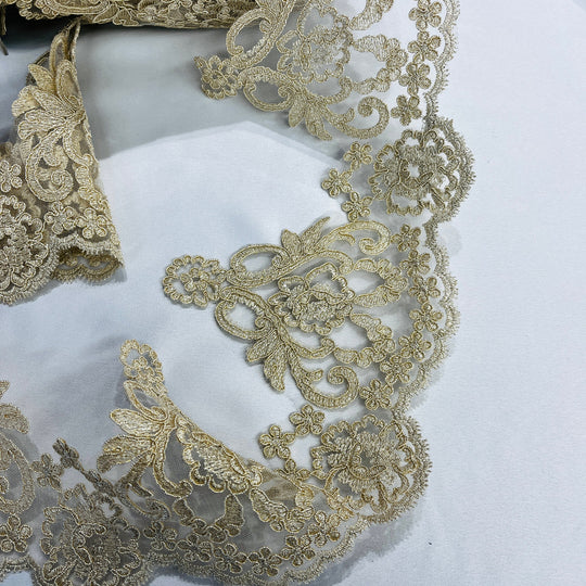 Closeup of Ornate Antique gold embroidered lace trim with delicate cording, symmetrical floral patterns, and fine detailing | Lace USA - 97214W