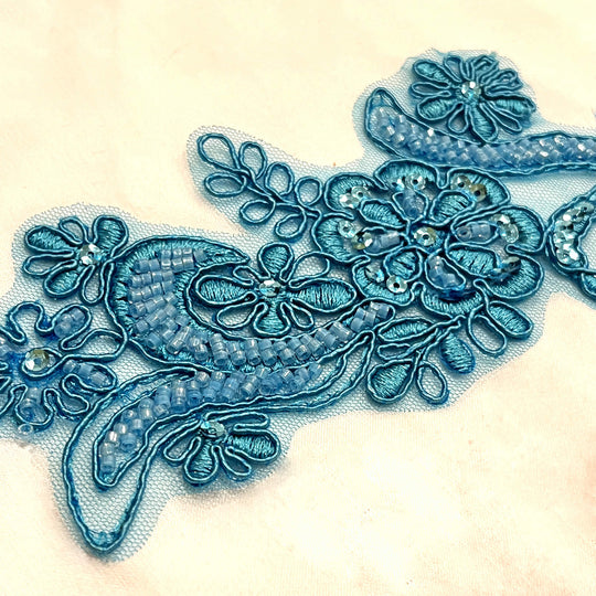 Closeup of Teal Color Beaded & Corded Floral Lace Applique Embroidered on 100% Polyester Net Meshh | Lace USA - KZ-67HB