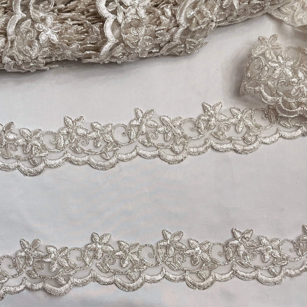 Closeup of Beaded Ivory with Silver  Cording Lace Trimming Embroidered on 100% Polyester Net Mesh | Lace USA - 97012W-BP