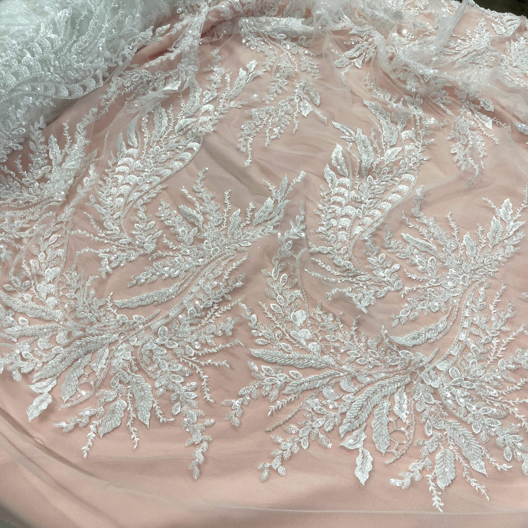 Partial view of Beaded Off White lace fabric with embroidered leaf design, sequins, and beads – ideal for Bridal gowns and Dance Costumes - LaceUSA GD12695