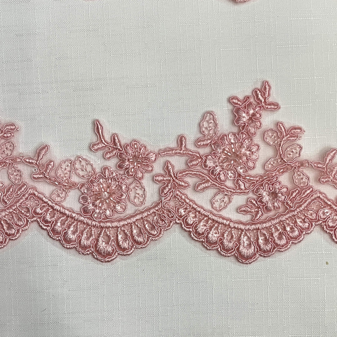 Closeup of Pink beaded corded floral scalloped lace embroidered on polyester net mesh - LaceUSA 96215WHB