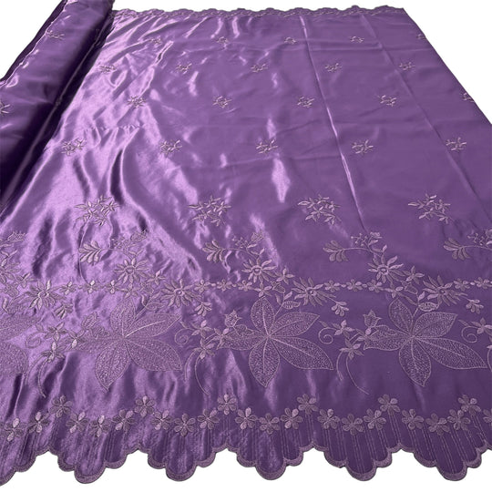 Plum satin fabric with embroidered floral patterns and a scalloped border, shown partially rolled on the left side against a white background.