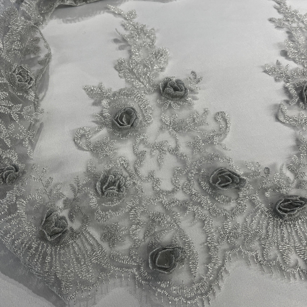 Close-up of a silver lace trim with intricate silver 3D rose embroidery sew with metalic thread. LaceUSA #21856W