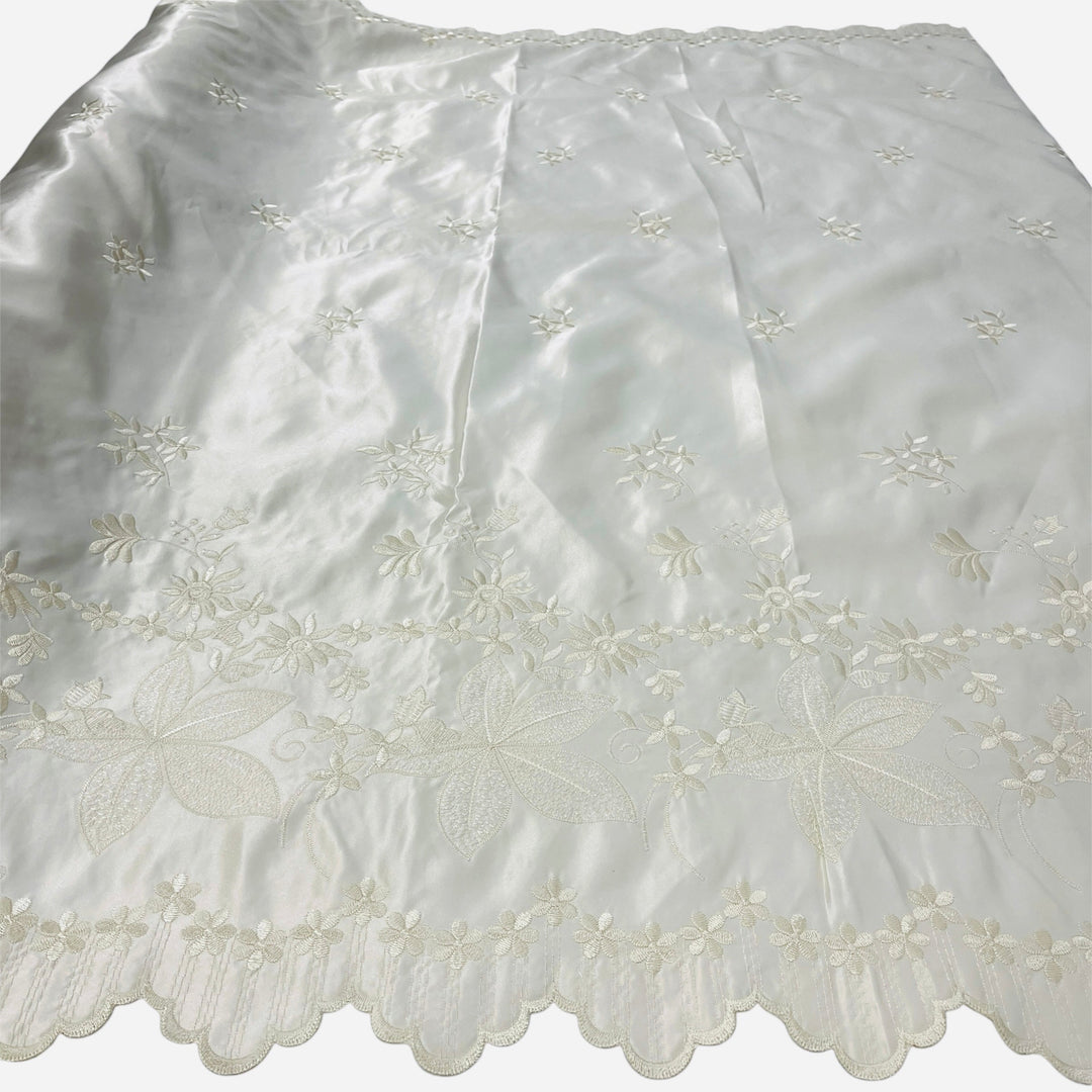champagne_satin_fabric_with_embroidered_floral_patterns_Lace_USA_31051Ssatin fabric with delicate floral embroidery and a scalloped lace border, laid flat against a white background.