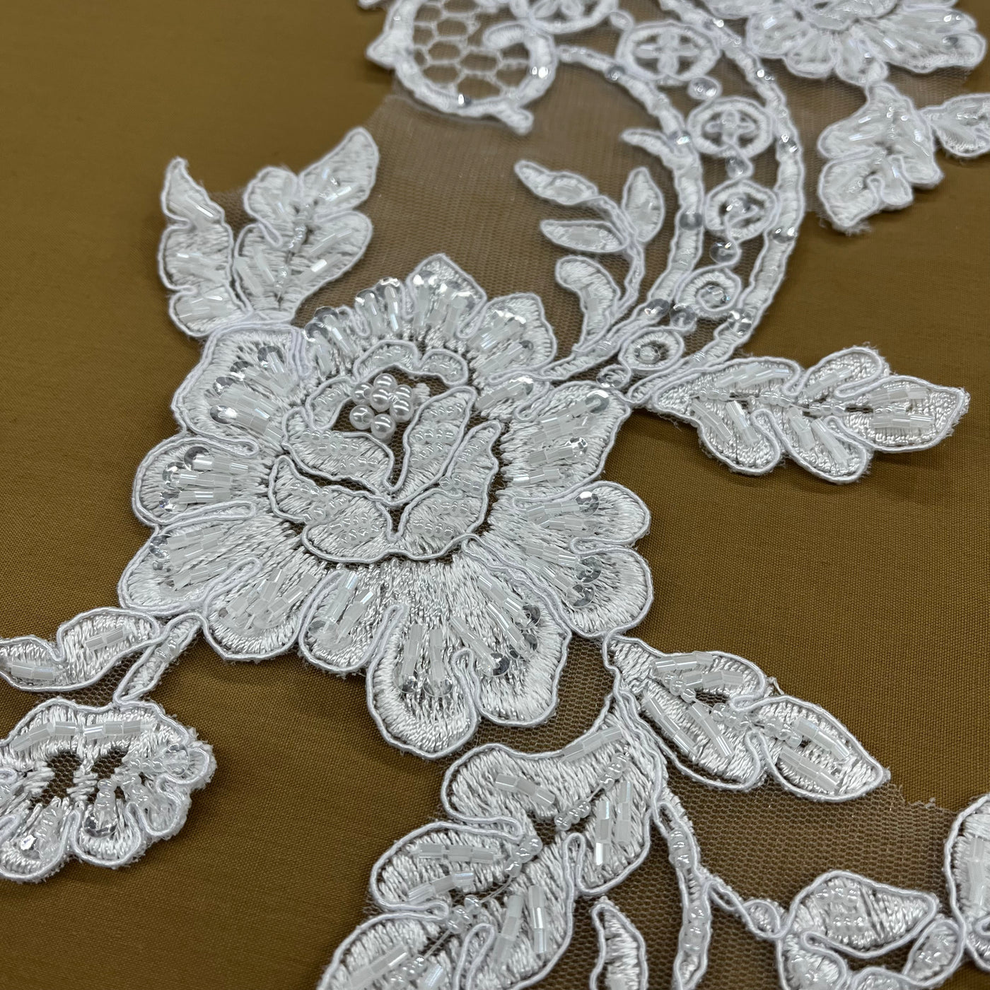 Beaded & Corded Floral Appliqué Lace Embroidered on 100% Polyester Organza or Net Mesh. This can be applied to Theatrical dance ballroom costumes, bridal dresses, bridal headbands endless possibilities. Sold By Pair Lace Usa