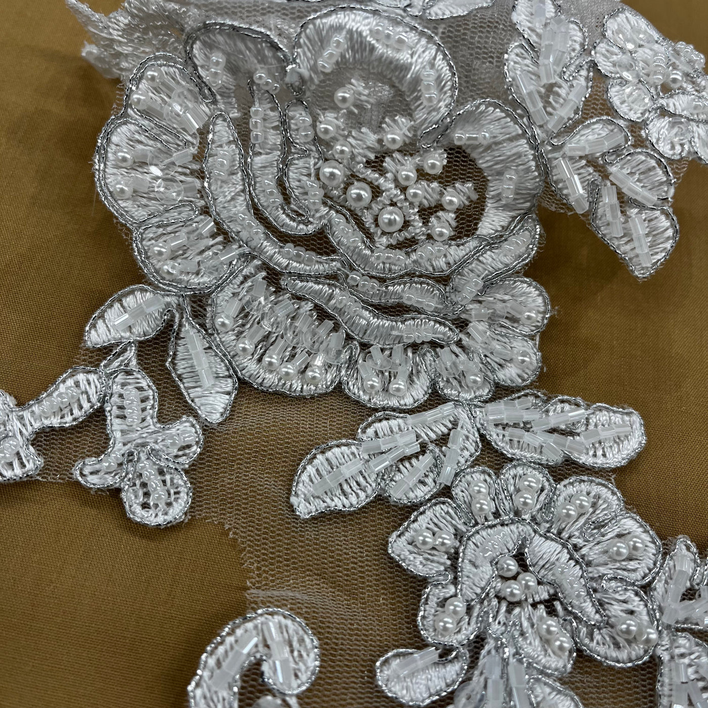 Beaded & Corded Floral Appliqué Lace Embroidered on 100% Polyester Organza or Net Mesh. This can be applied to Theatrical dance ballroom costumes, bridal dresses, bridal headbands endless possibilities. Sold By Pair Lace Usa