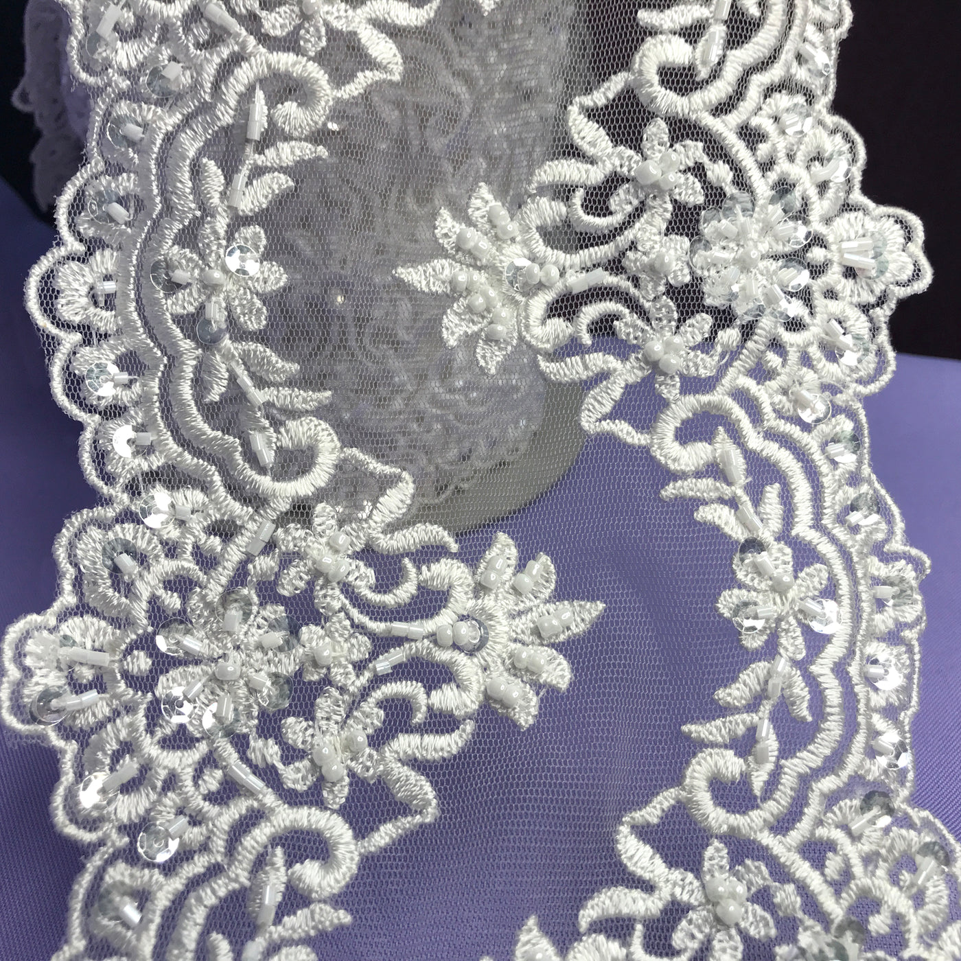 Double Sided Beaded White Trimming, Embroidered on 100 % Polyester Net Mesh.  Sold by the Yard.  Lace Usa