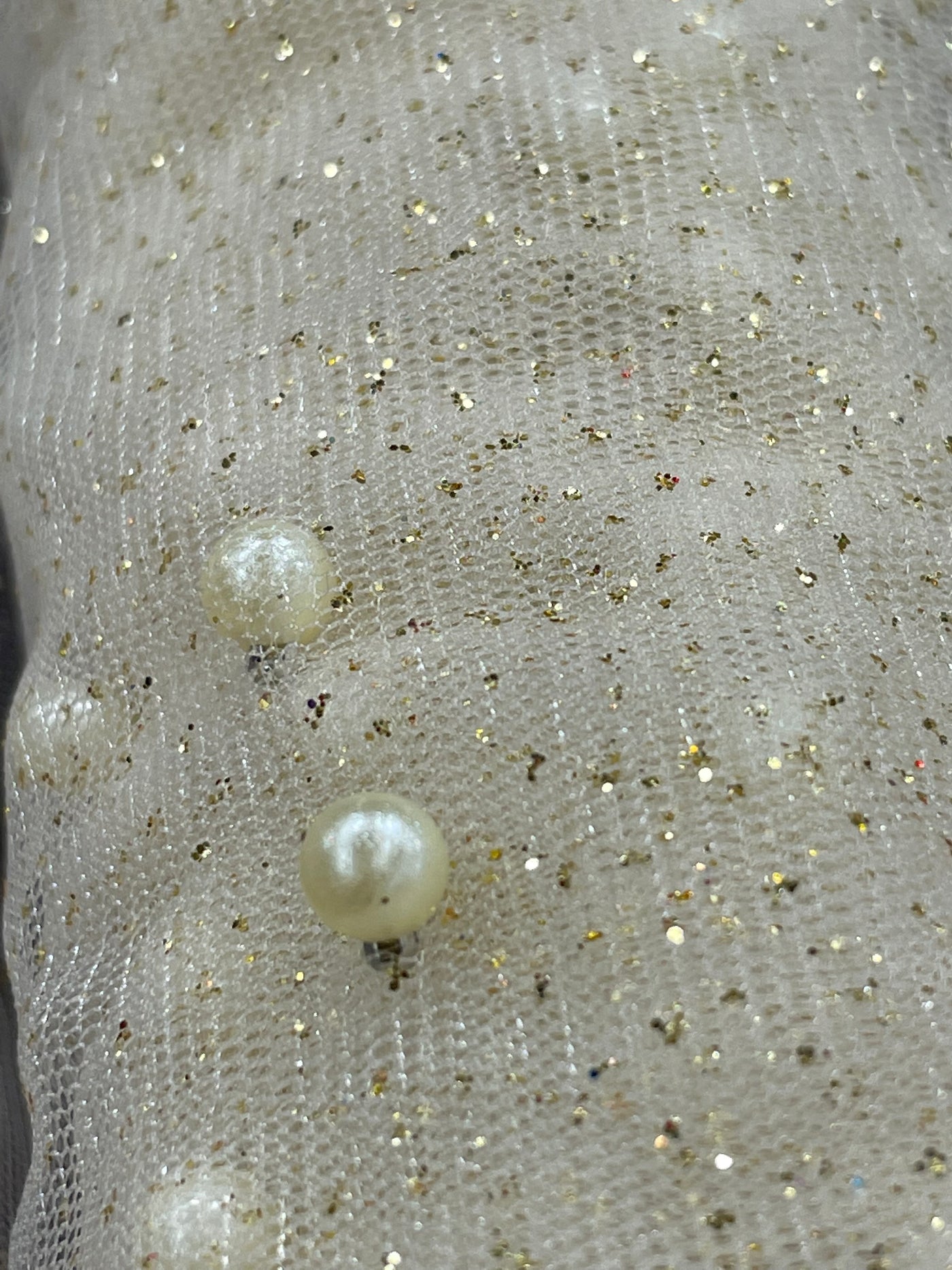 Glitter Mesh Net With Scattered Pearl , 2-Way Stretch, sold by the yard. 100% Polyester 60" wide. This mesh fabric is a 2-way stretch on the width. Pearls are scattered across the mesh.  Sold by the yard, 1-quantity equals to 1-yard.  If you order more than 1-yard, it will be ship in one continuous length.    Lace Usa