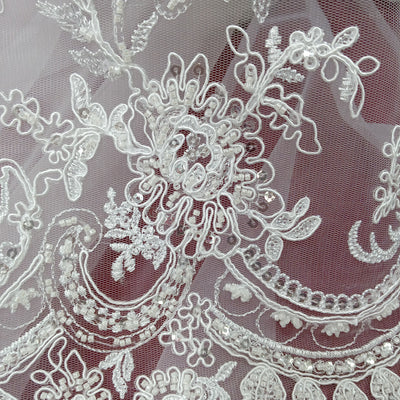 Corded & Beaded Bridal Lace Fabric Embroidered on 100% Polyester Net Mesh.  Sold the yard.  Lace Usa