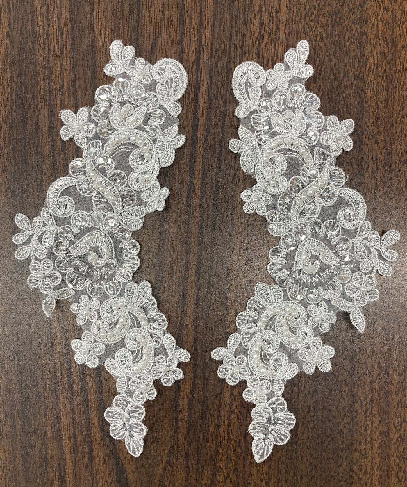 Beaded & Corded Floral Appliqué Lace Embroidered on 100% Polyester Organza or Net Mesh. This can be applied to Theatrical dance ballroom costumes, bridal dresses, bridal headbands endless possibilities.  Sold By Pair.  Lace Usa  Sold in a set of 2.