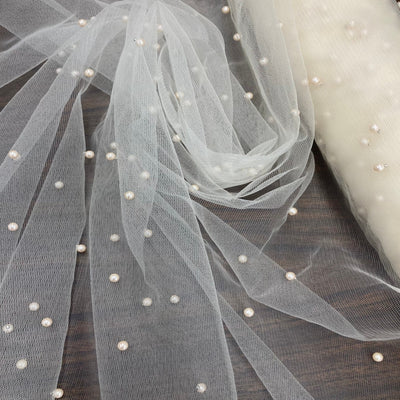 Mesh Net With Scattered Pearl , 2-Way Stretch, sold by the yard. 100% Polyester 60" wide. This mesh fabric is a 2-way stretch on the width. Pearls are scattered across the mesh.  Sold by the yard, 1-quantity equals to 1-yard.  If you order more than 1-yard, it will be ship in one continuous length.    Lace Usa