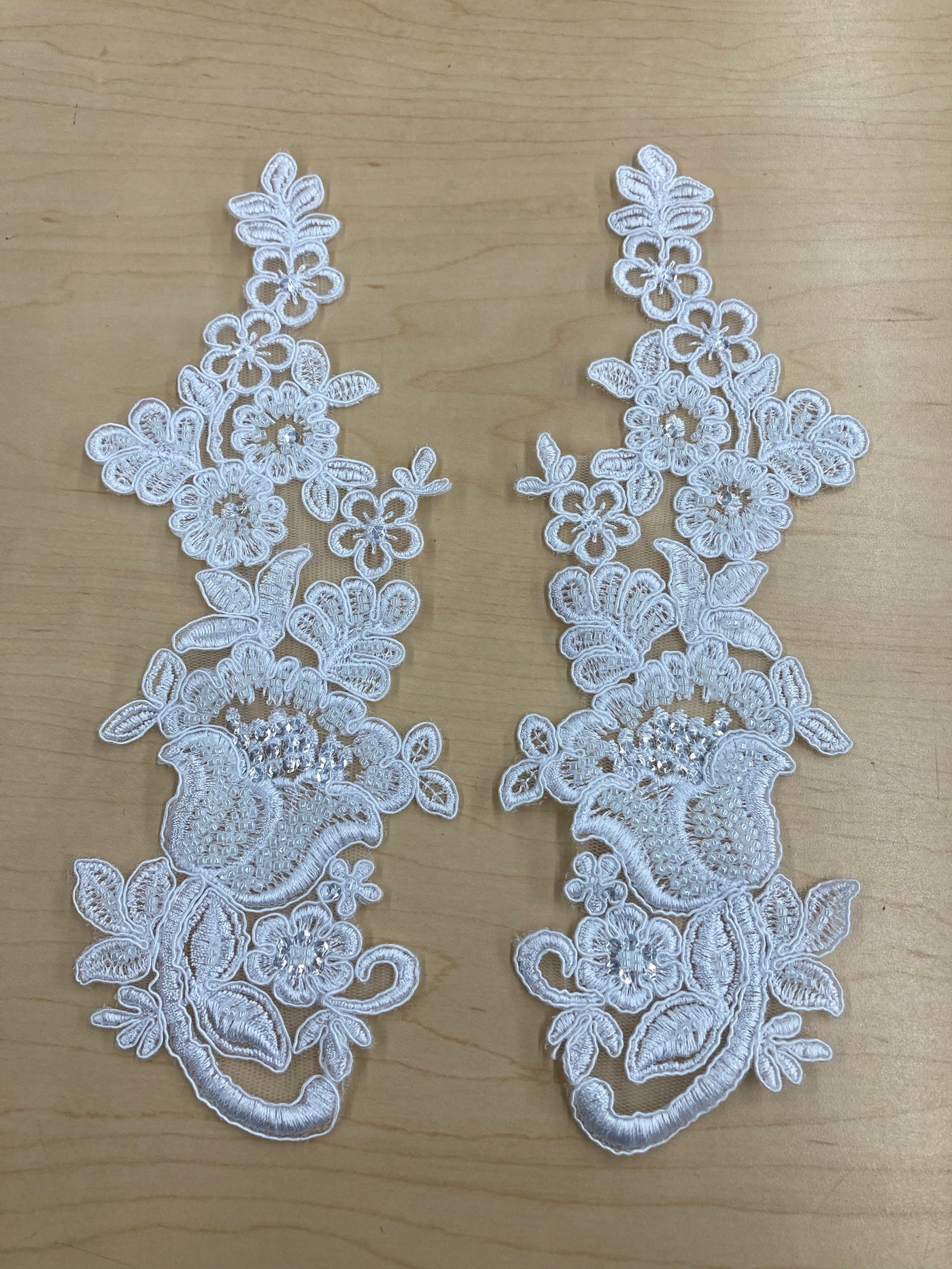 Beaded & Corded Floral White Appliqué Lace Embroidered on 100% Polyester Mesh Net. This can be applied to lyrical dance ballroom costumes, bridal dresses, bridal headbands endless possibilities.  Sold By Pair  Lace Usa